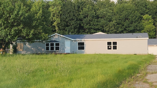 back of house with a lawn