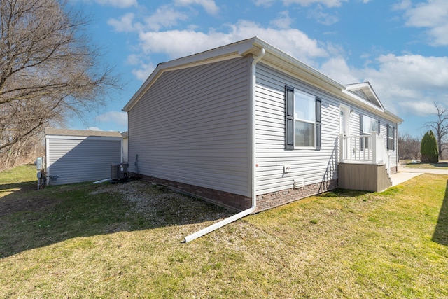 view of side of property featuring a yard and cooling unit