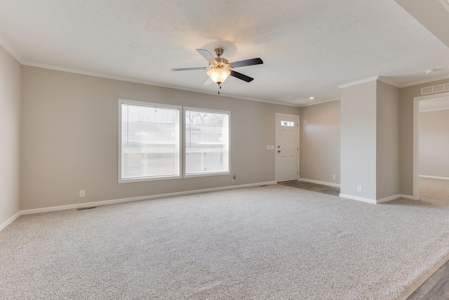 unfurnished room featuring a textured ceiling, ceiling fan, crown molding, and light carpet