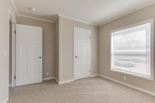 unfurnished bedroom featuring multiple windows, light colored carpet, and ornamental molding