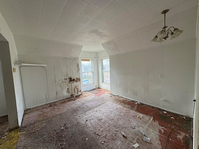 unfurnished room with a chandelier and lofted ceiling