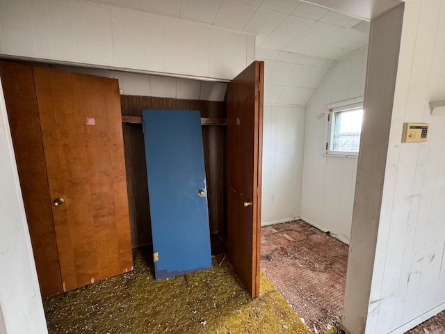 interior space with wooden walls and lofted ceiling