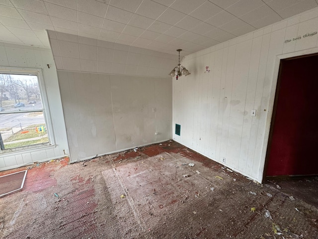 empty room with a notable chandelier