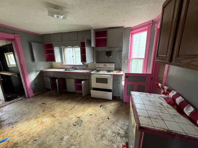 kitchen featuring tasteful backsplash, a textured ceiling, sink, tile countertops, and white range with electric cooktop