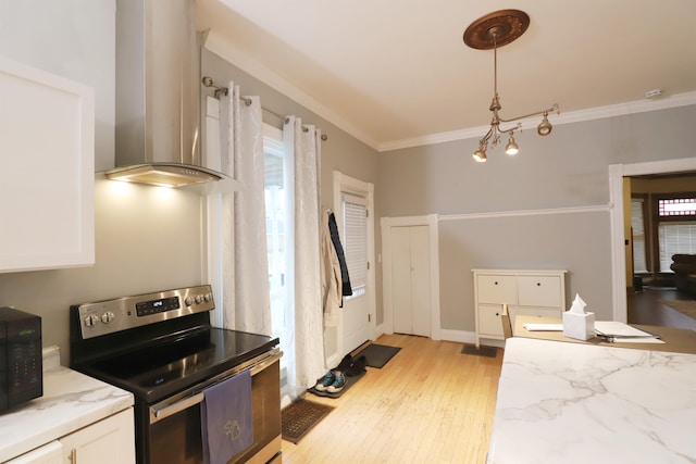 kitchen featuring white cabinets, light hardwood / wood-style flooring, plenty of natural light, and stainless steel range with electric stovetop