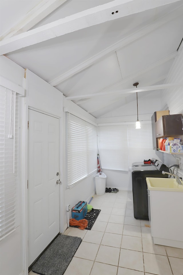 basement with washer / clothes dryer, sink, and light tile patterned floors