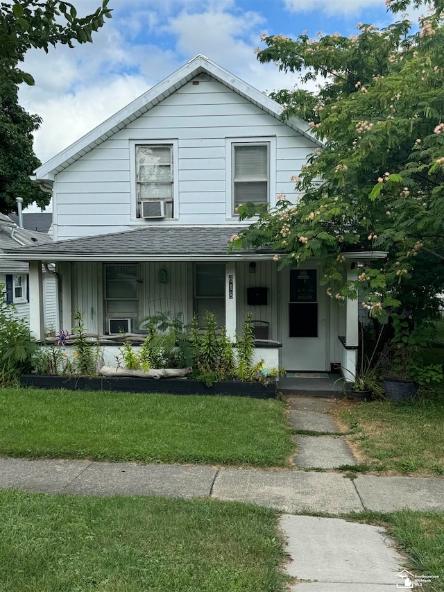 view of front of house with a porch and a front lawn