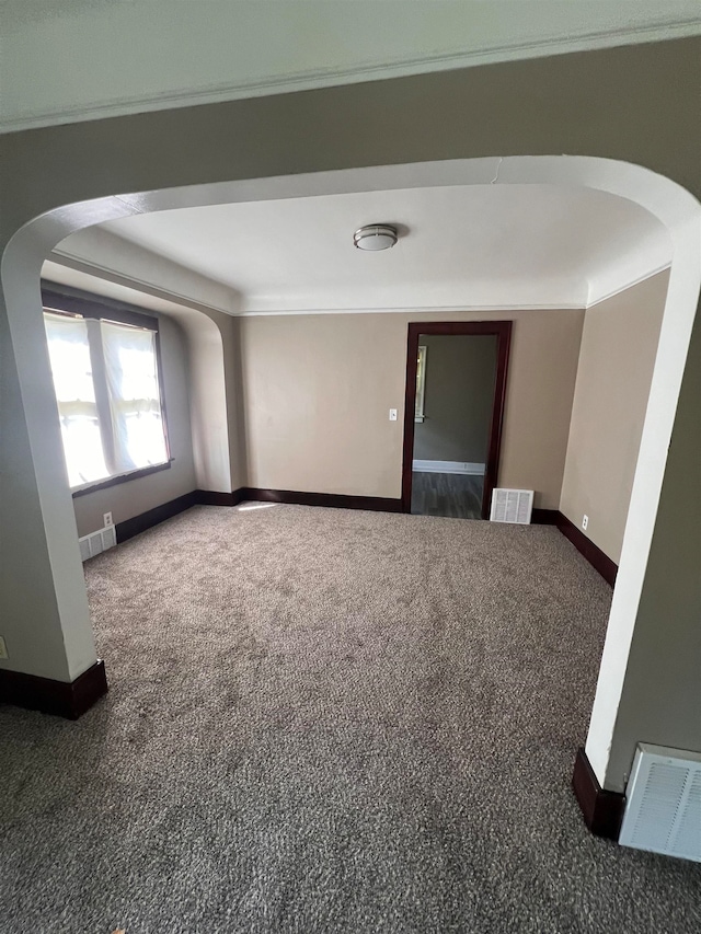 carpeted spare room with crown molding