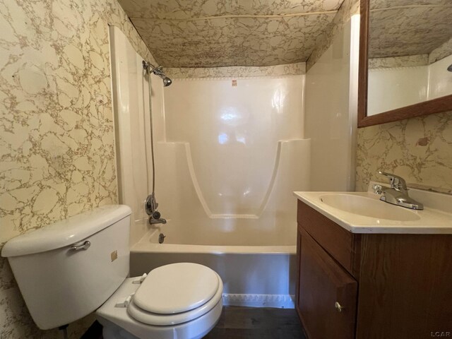 474 Merrick St, Adrian, MI 49221 - bathroom with wallpapered walls, vanity, toilet, and shower / bathtub combination