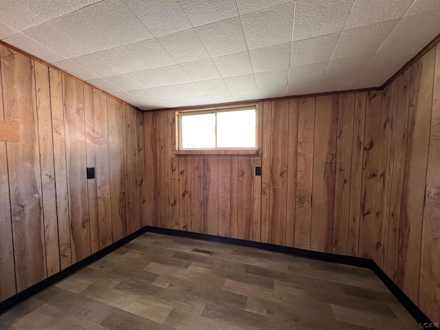 474 Merrick St, Adrian, MI 49221 - spare room featuring wood finished floors, wood walls, and baseboards