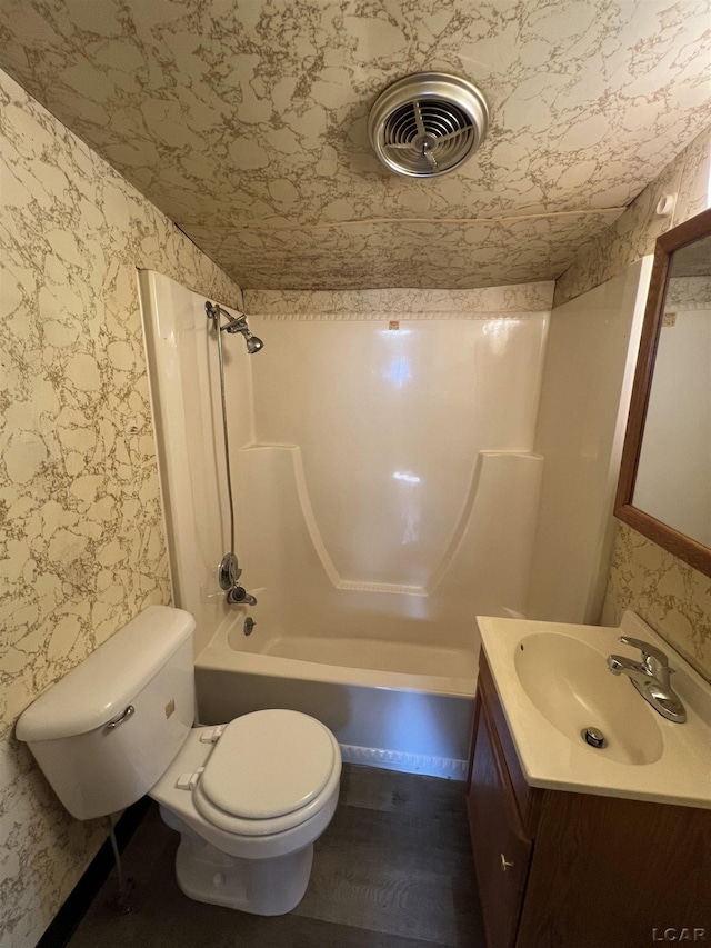 474 Merrick St, Adrian, MI 49221 - full bath with wallpapered walls, toilet, vanity, shower / bathtub combination, and wood finished floors