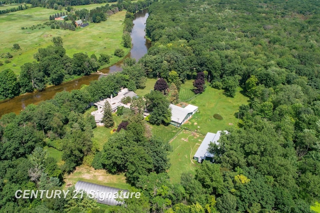 birds eye view of property with a forest view and a water view