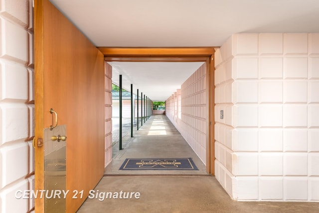 hall featuring concrete floors