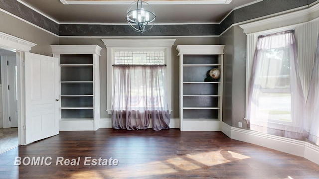 interior space with dark hardwood / wood-style flooring, an inviting chandelier, and crown molding