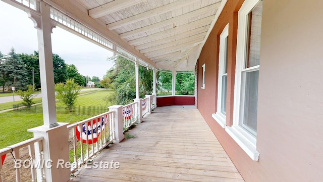 deck featuring a porch and a yard