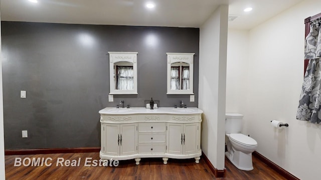 bathroom featuring hardwood / wood-style floors, vanity, and toilet