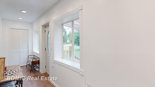 doorway featuring wood walls and hardwood / wood-style floors