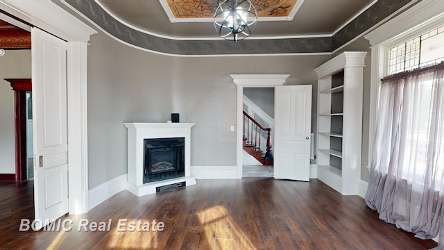 unfurnished living room with a tray ceiling, dark hardwood / wood-style floors, and crown molding