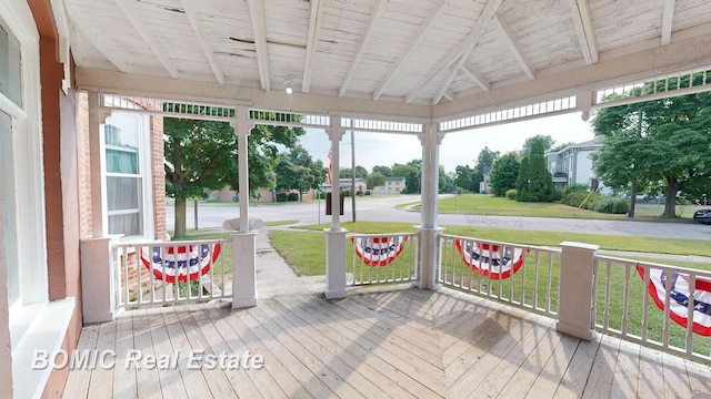 unfurnished sunroom with vaulted ceiling with beams and wood ceiling