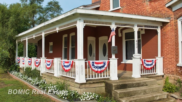 view of side of home with a porch