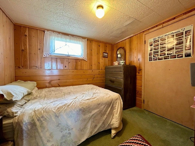 carpeted bedroom with wood walls