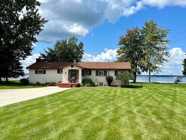 ranch-style home featuring a water view, a front yard, and central AC