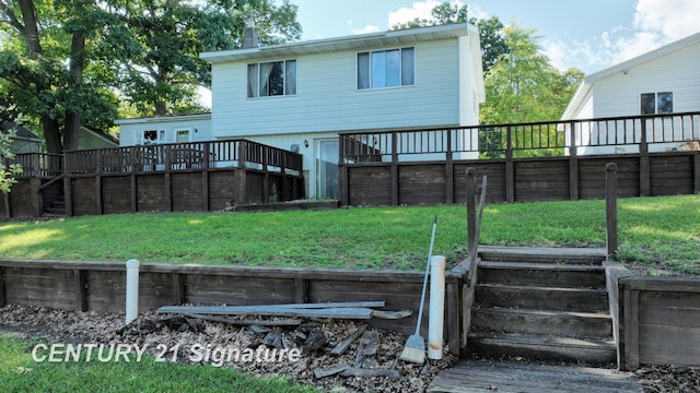 rear view of house with a lawn and a wooden deck