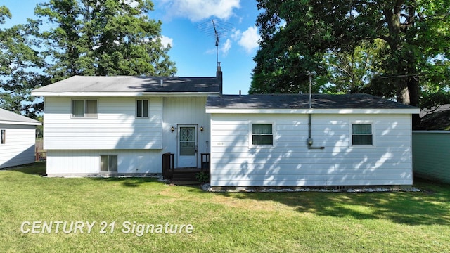 rear view of property featuring a yard