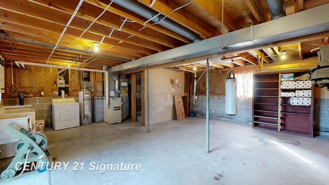 basement featuring gas water heater, separate washer and dryer, and heating unit