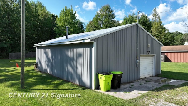 view of outdoor structure featuring a yard and a garage