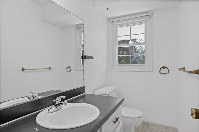 bathroom with tile patterned flooring, vanity, and toilet