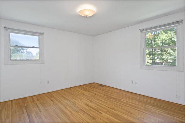 spare room with light wood-type flooring