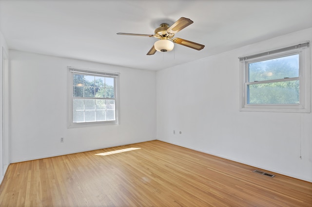 spare room with light hardwood / wood-style flooring and ceiling fan