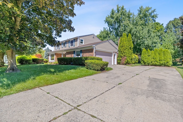 view of front property featuring a front lawn and a garage