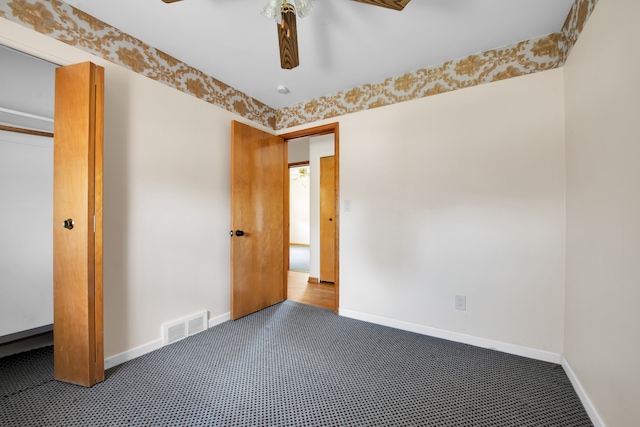 unfurnished bedroom with carpet, ceiling fan, and a closet