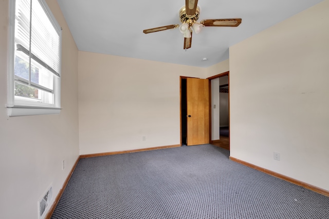 empty room featuring ceiling fan and carpet floors