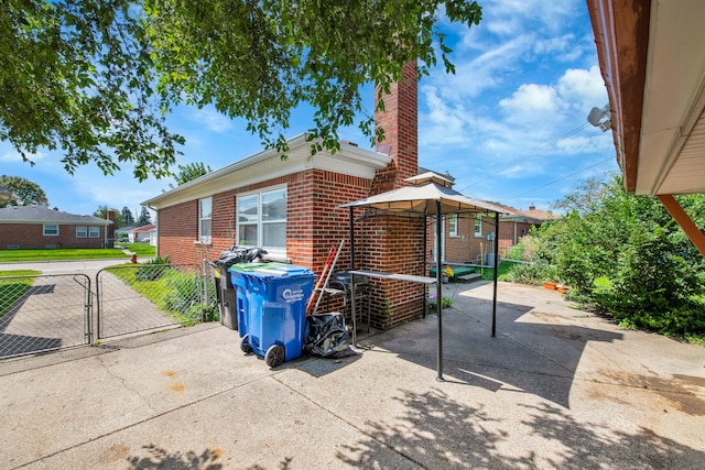 view of side of property with a patio area