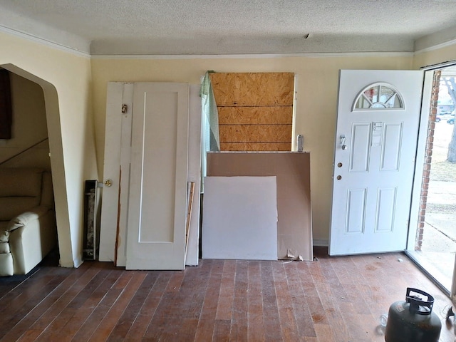 entryway with a textured ceiling and hardwood / wood-style flooring