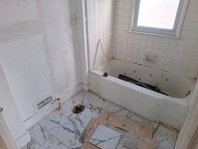 bathroom featuring a tub to relax in