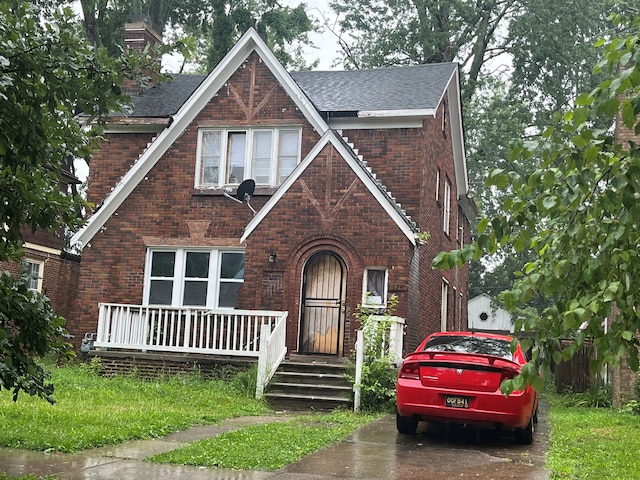 5919 Yorkshire Rd, Detroit, MI 48224 - english style home featuring brick siding, a shingled roof, and a chimney