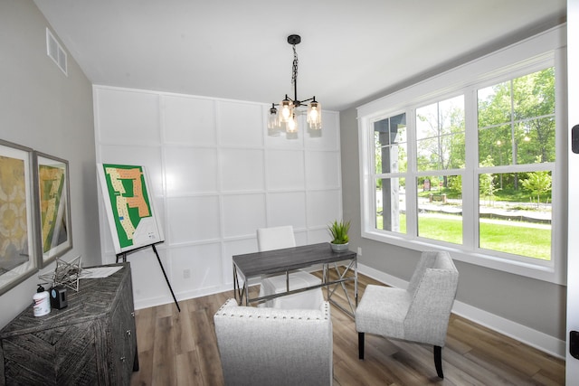 dining space featuring dark hardwood / wood-style flooring and a chandelier