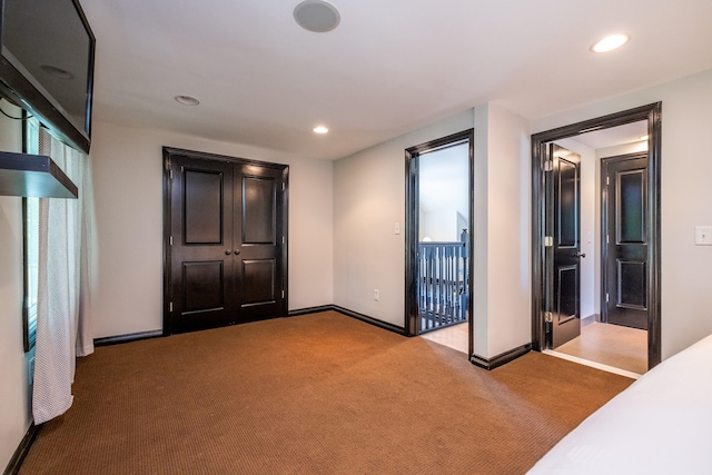 unfurnished bedroom featuring light colored carpet