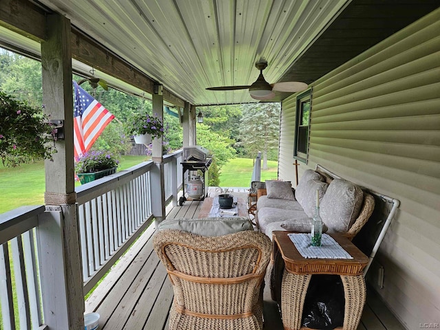 wooden terrace with covered porch, grilling area, and ceiling fan