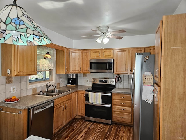 kitchen featuring pendant lighting, sink, ceiling fan, appliances with stainless steel finishes, and dark hardwood / wood-style flooring