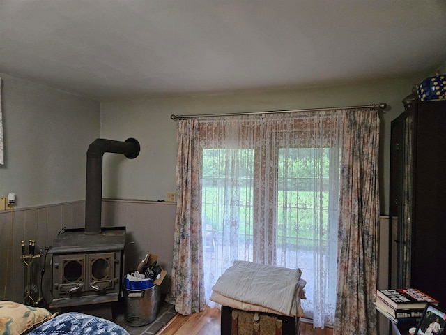 interior space with hardwood / wood-style flooring and a wood stove