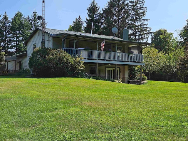 rear view of house with a lawn