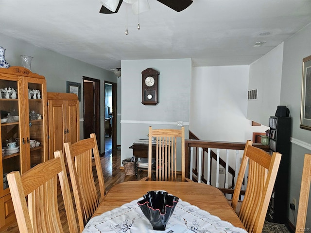 dining space with dark hardwood / wood-style flooring and ceiling fan