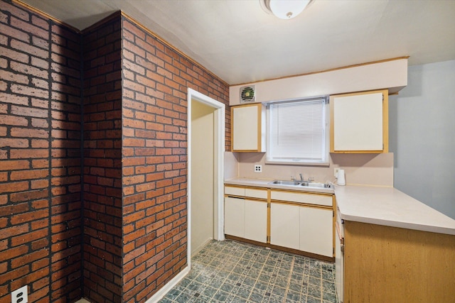 kitchen with sink and brick wall