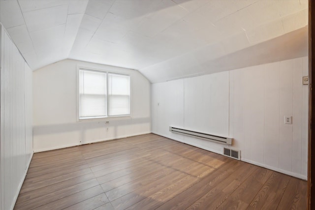 bonus room featuring hardwood / wood-style floors, lofted ceiling, and a baseboard heating unit