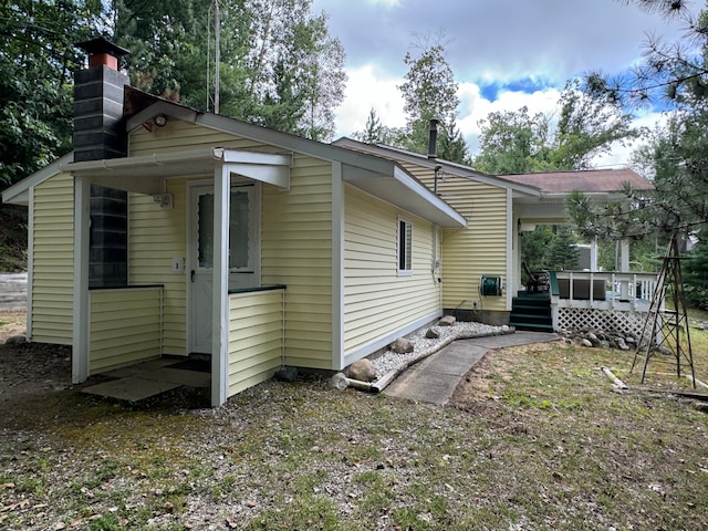 rear view of property with a wooden deck